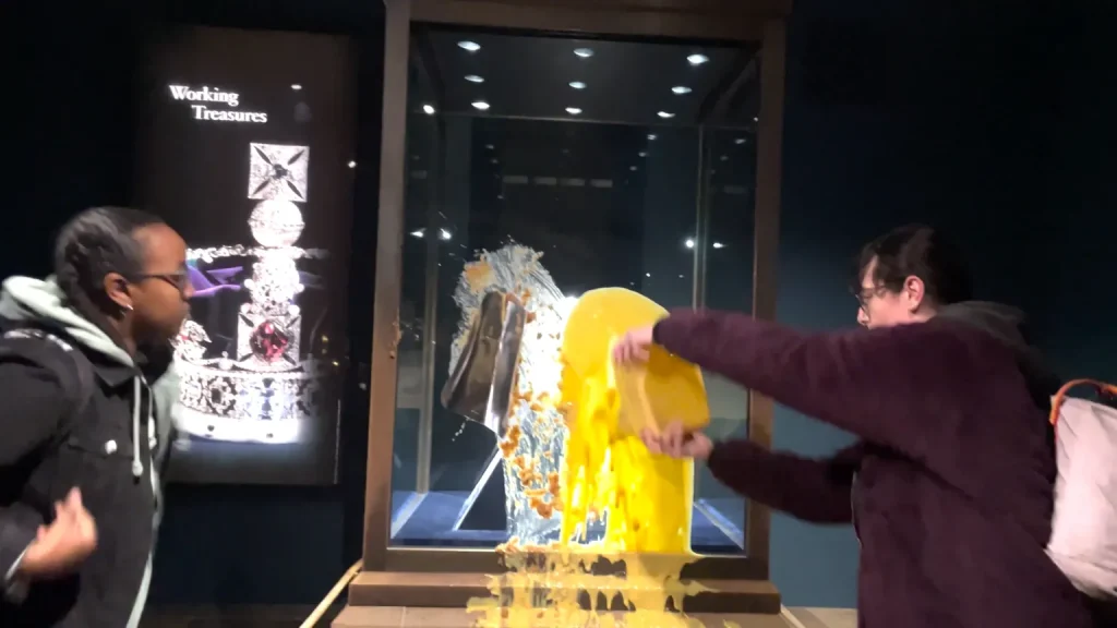 Four arrested after display case containing the Imperial State Crown is defaced with custard and crumble